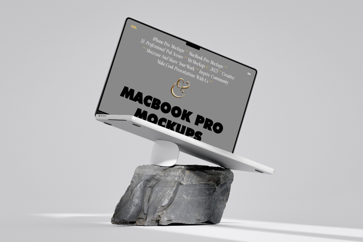 Front view, MacBook Pro Mockup with gray design standing on the white apple mouse and piece of rock against bright gray floor and wall.
