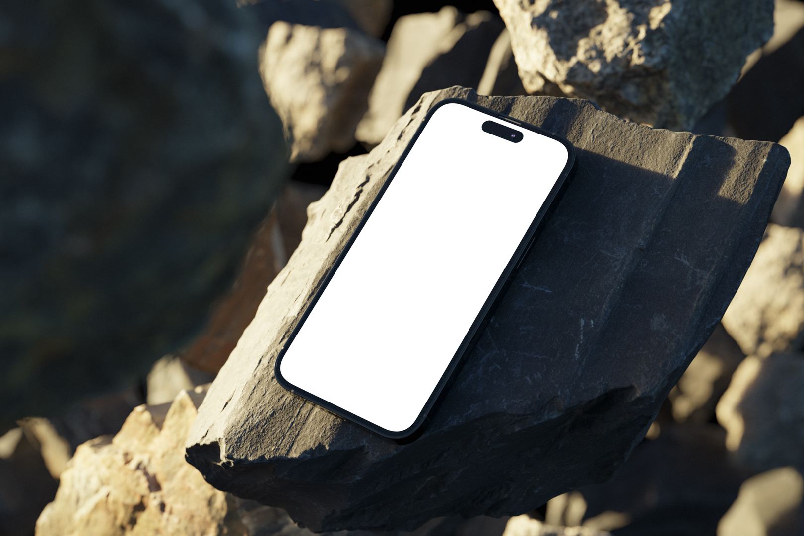 Seen from above, blank iPhone 14 Pro Mockup laying on the sunny rocks on the beach against water in the background.