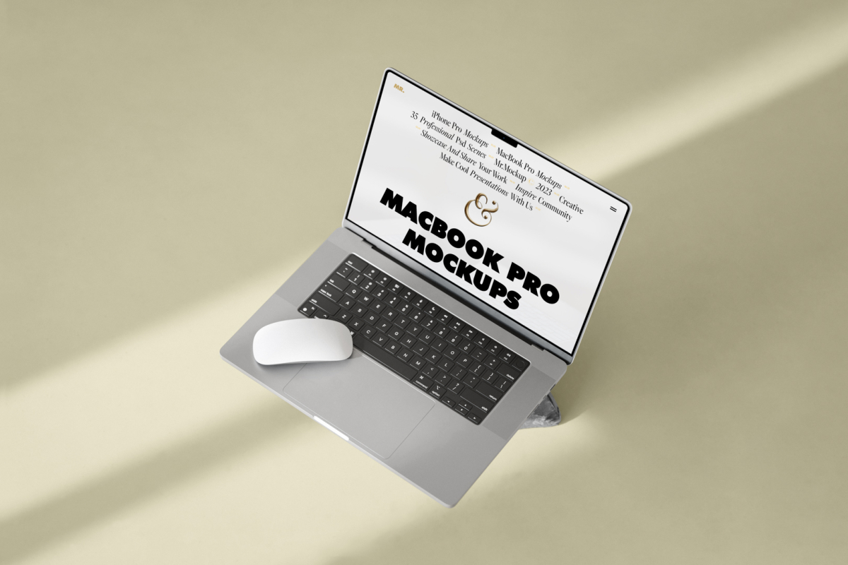 Seen from above, MacBook Pro Mockup with white design standing on the rock laying on the bright gold floor.