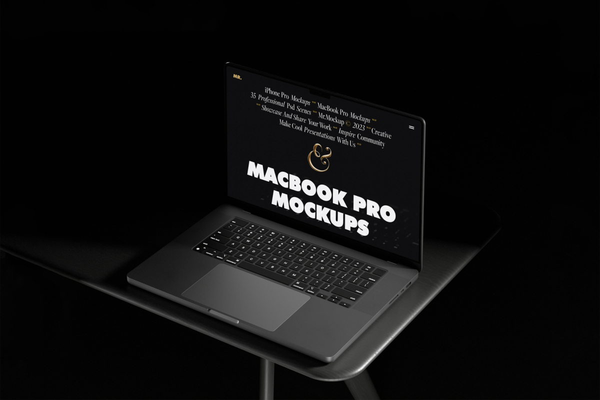 Seen from above, MacBook Pro Mockup with black design standing on the black desk against a deep black background.