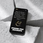 Seen from above, iPhone 14 Pro Mockup with black design laying on the pieces of a styrofoam laying on the white floor.