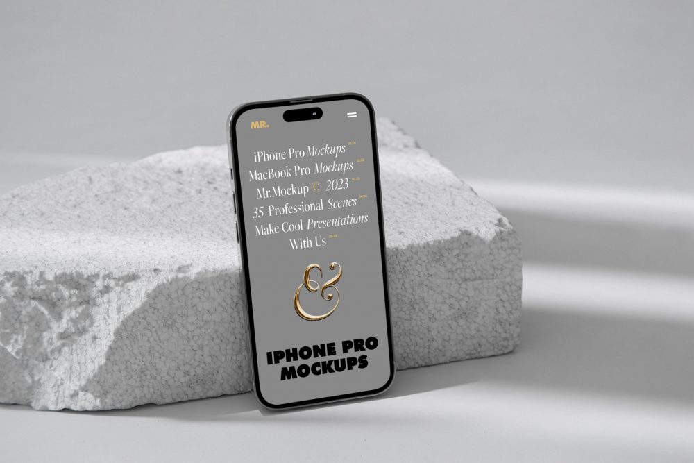 Front view iPhone 14 Pro Mockup with gray design based on the piece of a styrofoam and standing on the white floor against white wall.