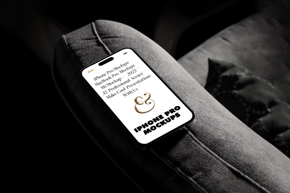 iPhone 14 Pro Mockup with white design seen from above laying on the dark gray couch.