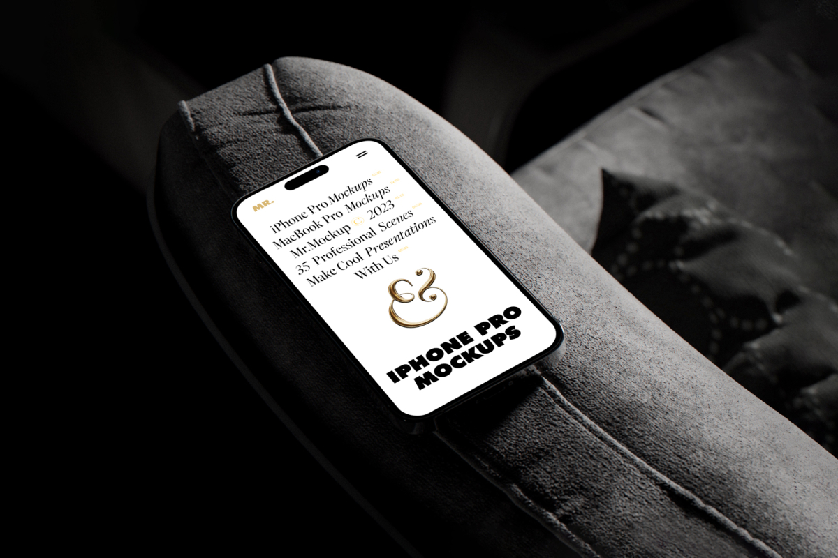 iPhone 14 Pro Mockup with white design seen from above laying on the dark gray couch.
