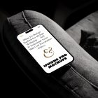 iPhone 14 Pro Mockup with white design seen from above laying on the dark gray couch.