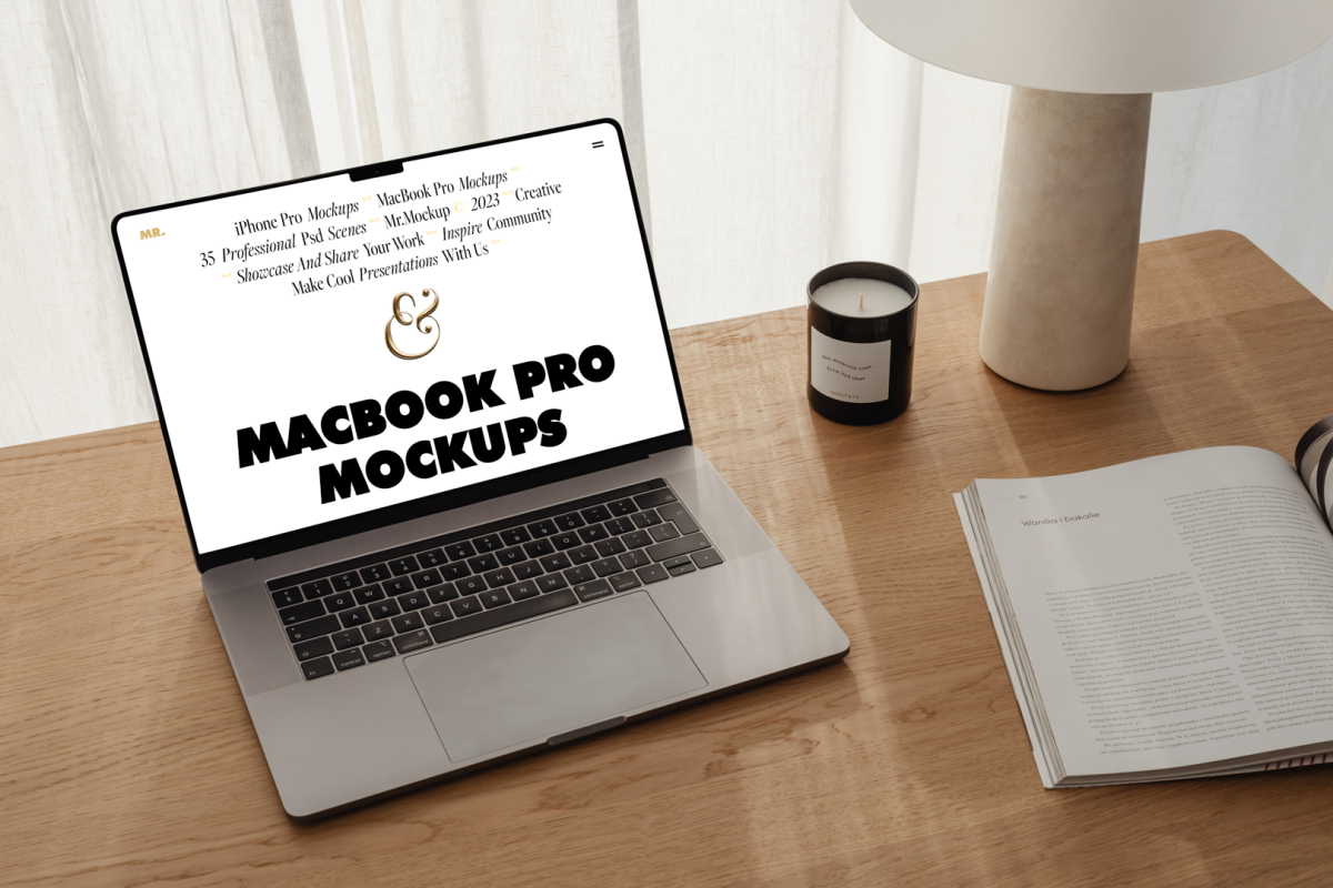 Front view MacBook Pro Mockups with white design laying on the wooden desk with a candle, magazine, and modern desk lamp against a white curtain.