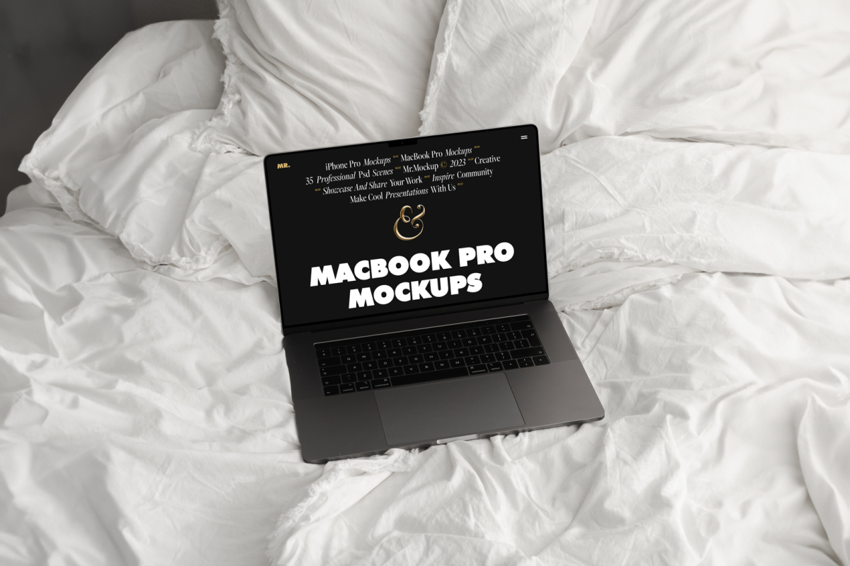 Front view MacBook Pro Mockups with black design laying on the white linen on bed.