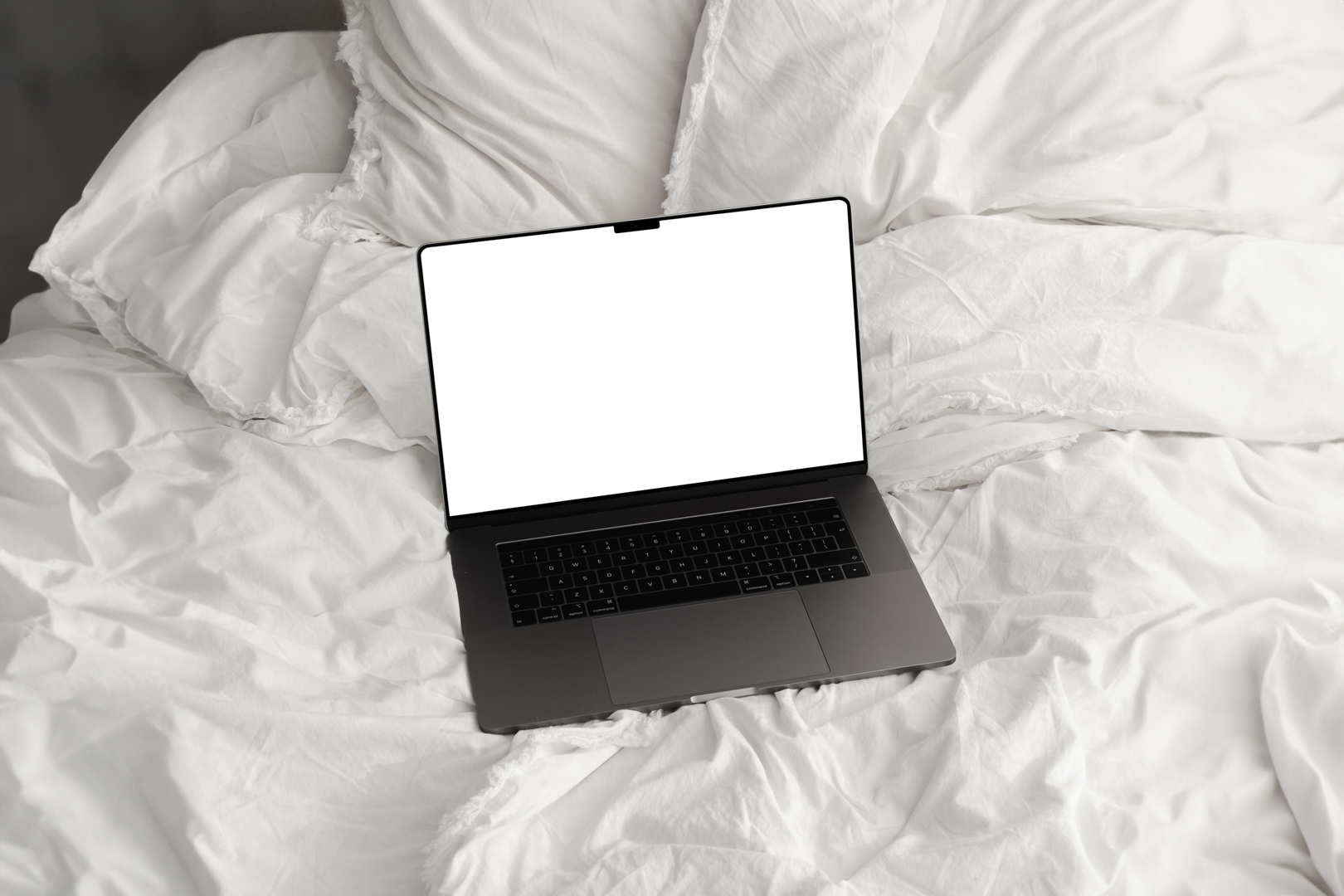 Front view, blank MacBook Pro Device Mockups laying on the white linen on bed.