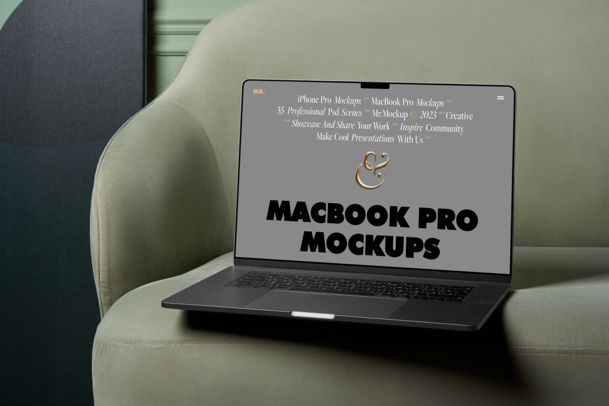 Front view MacBook Pro Mockups with gray design laying on the green couch against a green flat wall in the background.