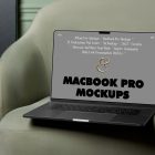 Front view MacBook Pro Mockups with gray design laying on the green couch against a green flat wall in the background.