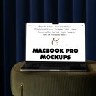 Front view MacBook Pro Mockups with white design laying on the bottle green pouf with gold elements against a deep blue curtain in the background.