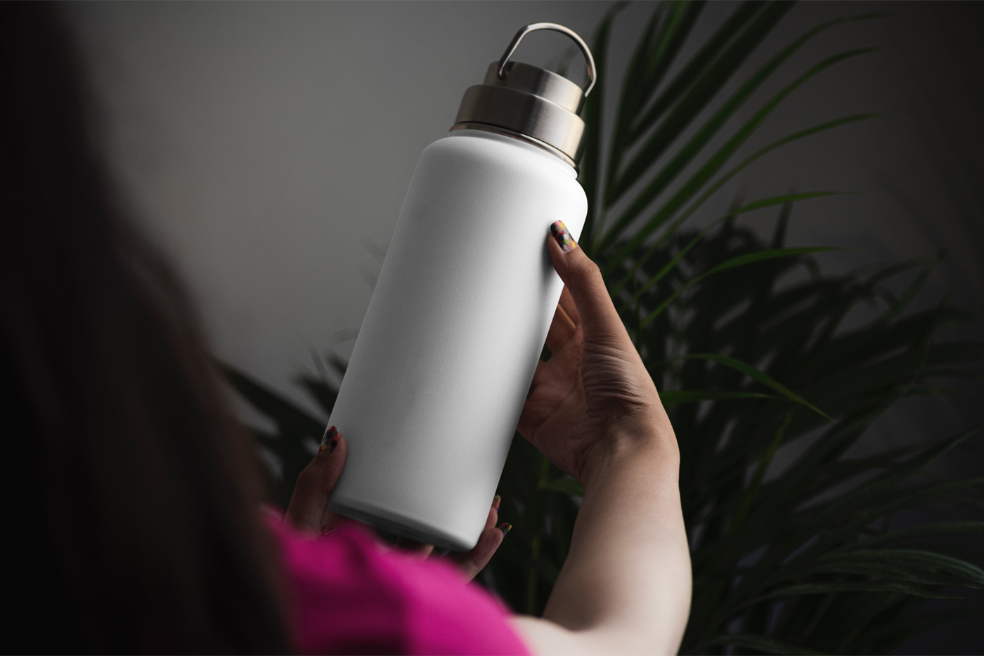 Front view, blank bottle mockup holding by women.