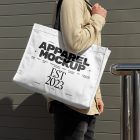 Front view, Men wearing a White Canvas Bag Mockup with a black handle and design on it against rotten green color wall.