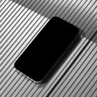 Seen from above, Blank iPhone 14 Pro Mockup laying on the silver plastic panel background.