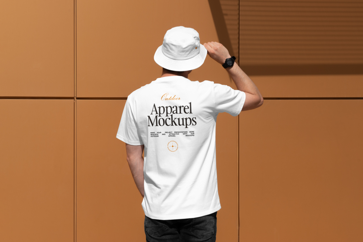 Front view, man with his back turned, wearing a white T-shirt Mockup and white Bucket Hat Mockup standing against on the gold wall.