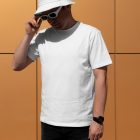 Front view, a man wearing a White T-shirt Mockup and a White Bucket Hat Mockup standing against on the gold wall.