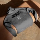 Seen from above, a gray Hoodie Mockup with a black and white typographic design on it laying on the creamy bench against the marble street.
