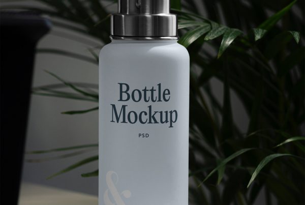 Front view, blue bottle mockup standing on a white table in front of the flowers.