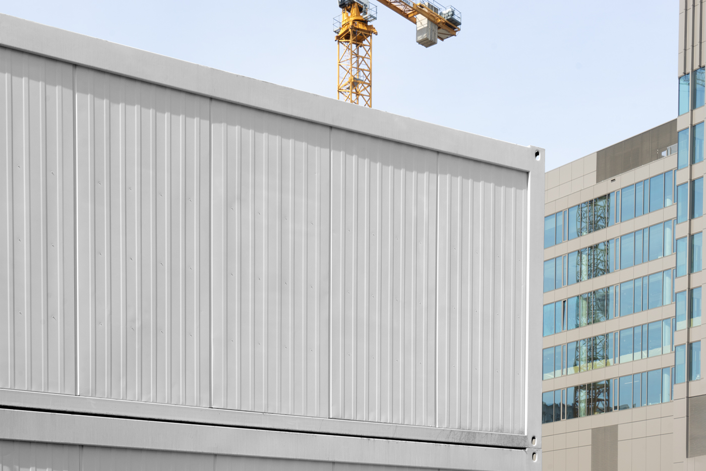 Front view, blank construction container mockup with a visible sky and buildings behind.