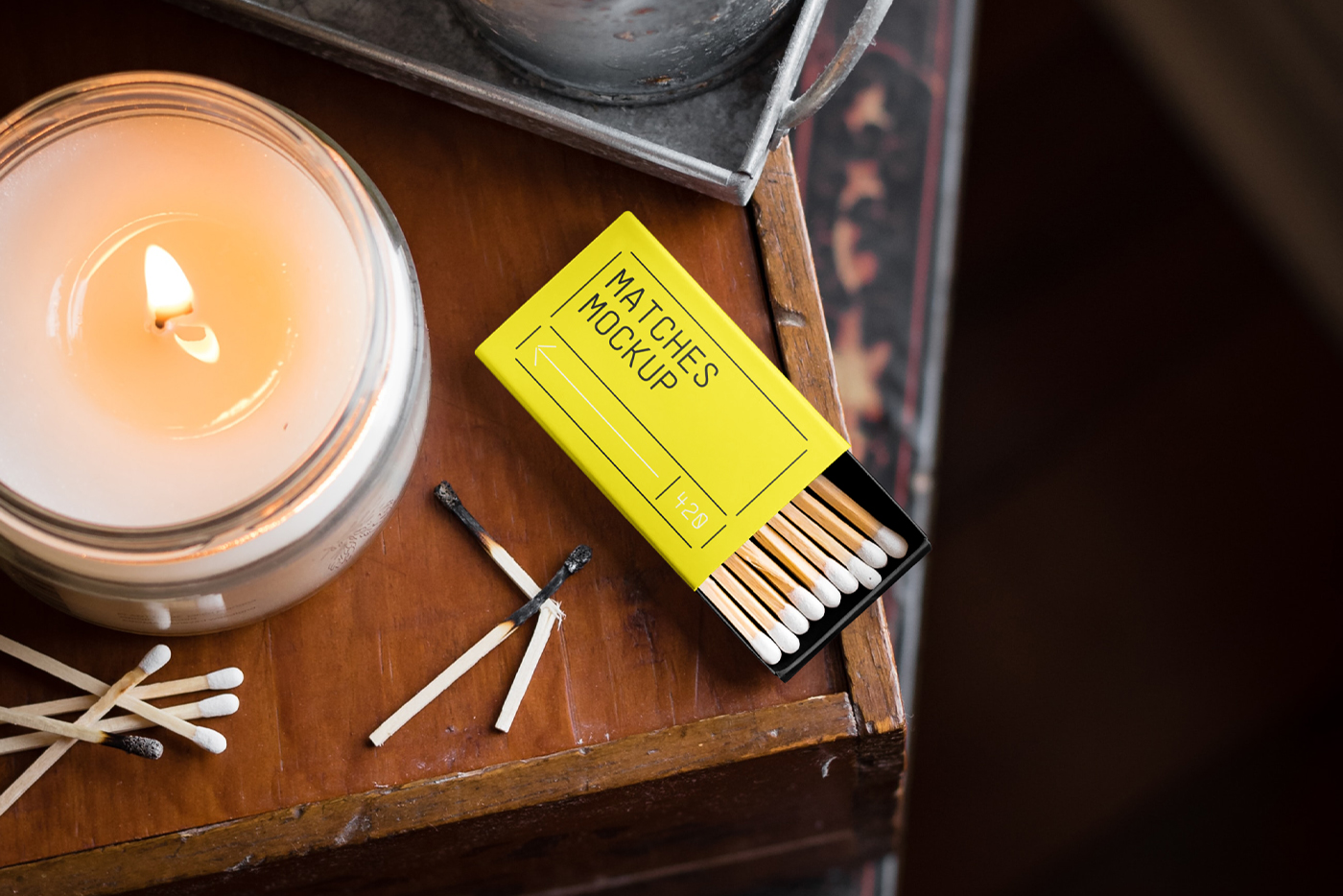 View from above, matches box mockup laying on the wooden chest of drawers.