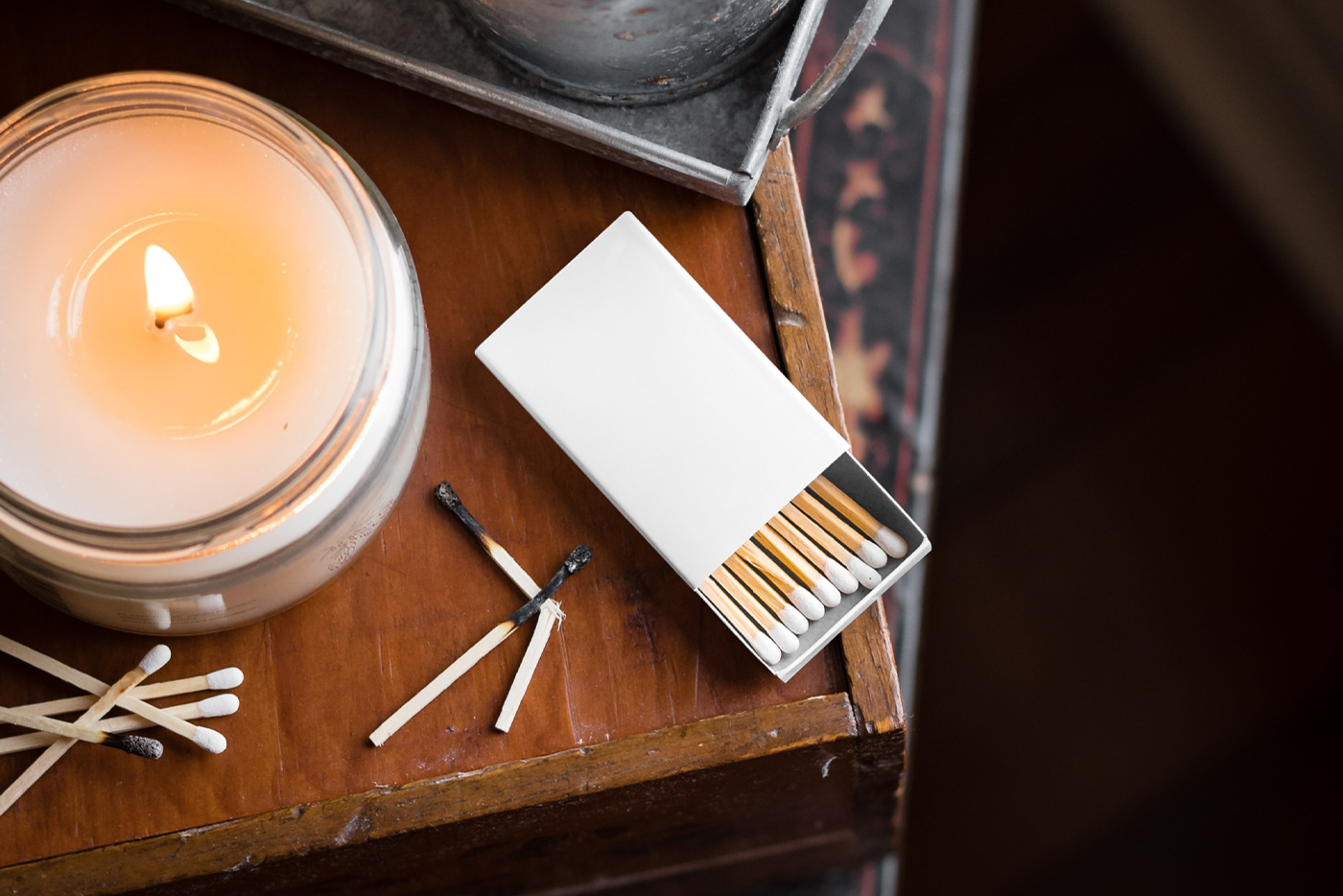 View from above, blank matches box mockup laying on the wooden chest of drawers.