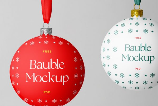 Front view, two Christmas Bauble Mockup hanging in front of the gray wall.