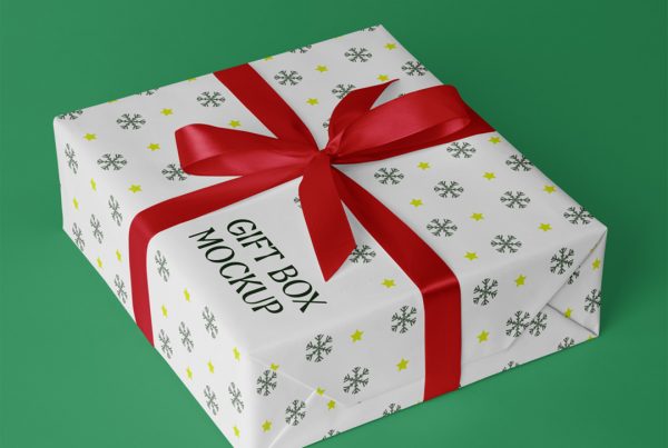White color gift boxes with red ribbon mockup laying on the green floor.