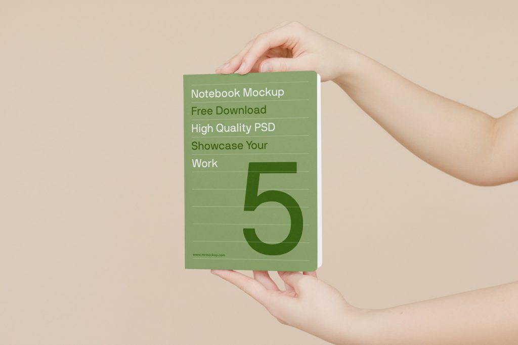 Front view, book mockup in man's hand in front of the beige wall.