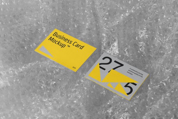 View from above, business card mockup laying on the transparent bauble foil.