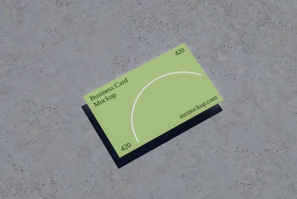View from above, business card mockup laying on the concrete floor.