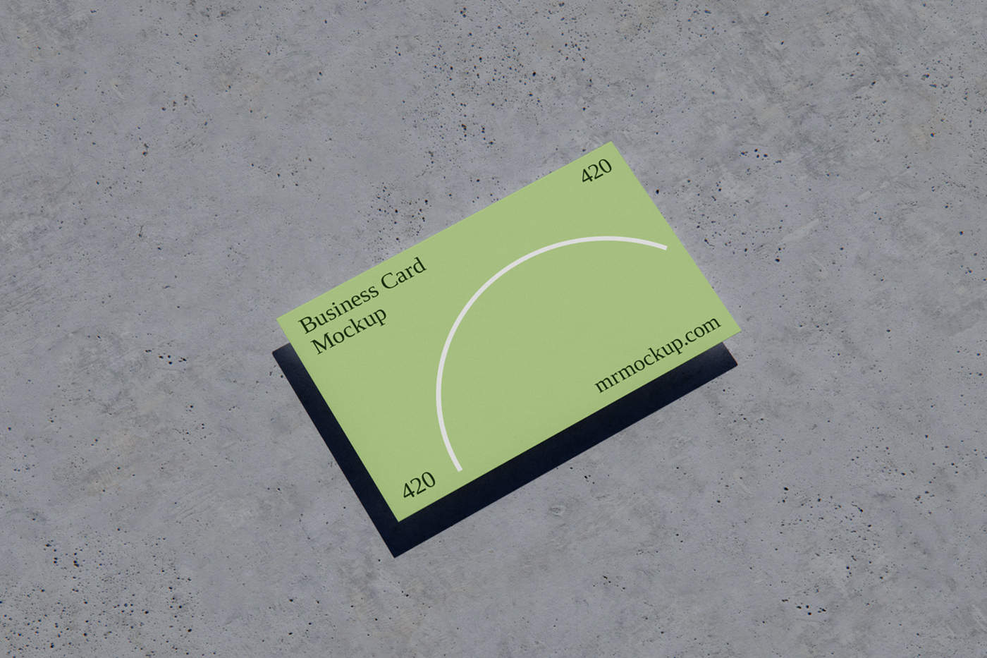View from above, business card mockup laying on the concrete floor.