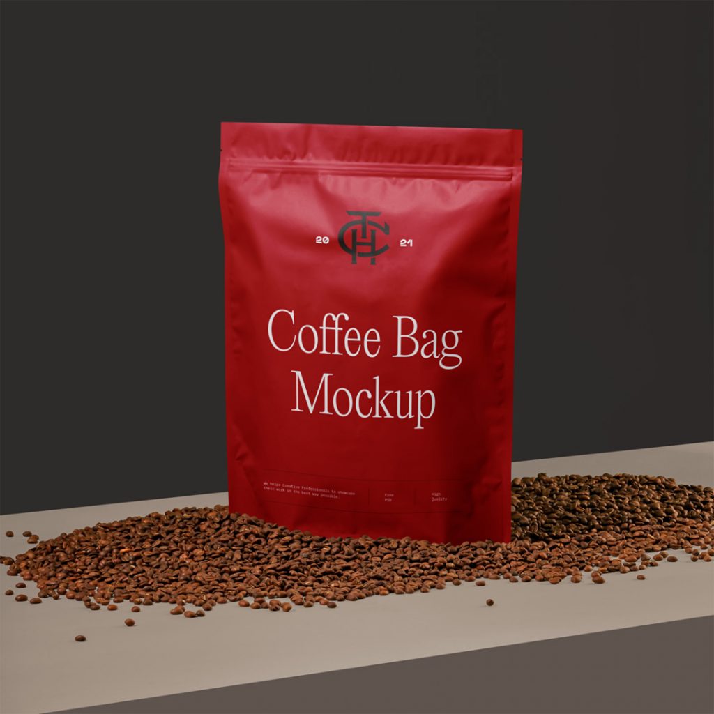 Front view, coffee bag mockup standing among coffee beans and brown box in front of the black wall.