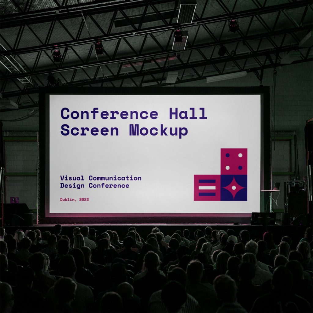 Front view, conference hall screen mockup inside the building with a visible audience.