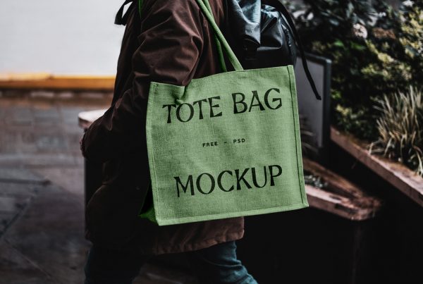 Green eco bag mockup carrying by man on his shoulder.