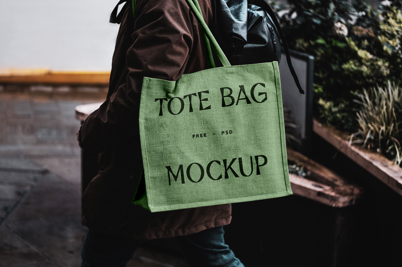 Green eco bag mockup carrying by man on his shoulder.