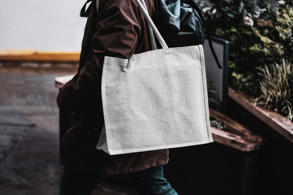 Free Eco Bag Carrying by Man Mockup — Mr.Mockup