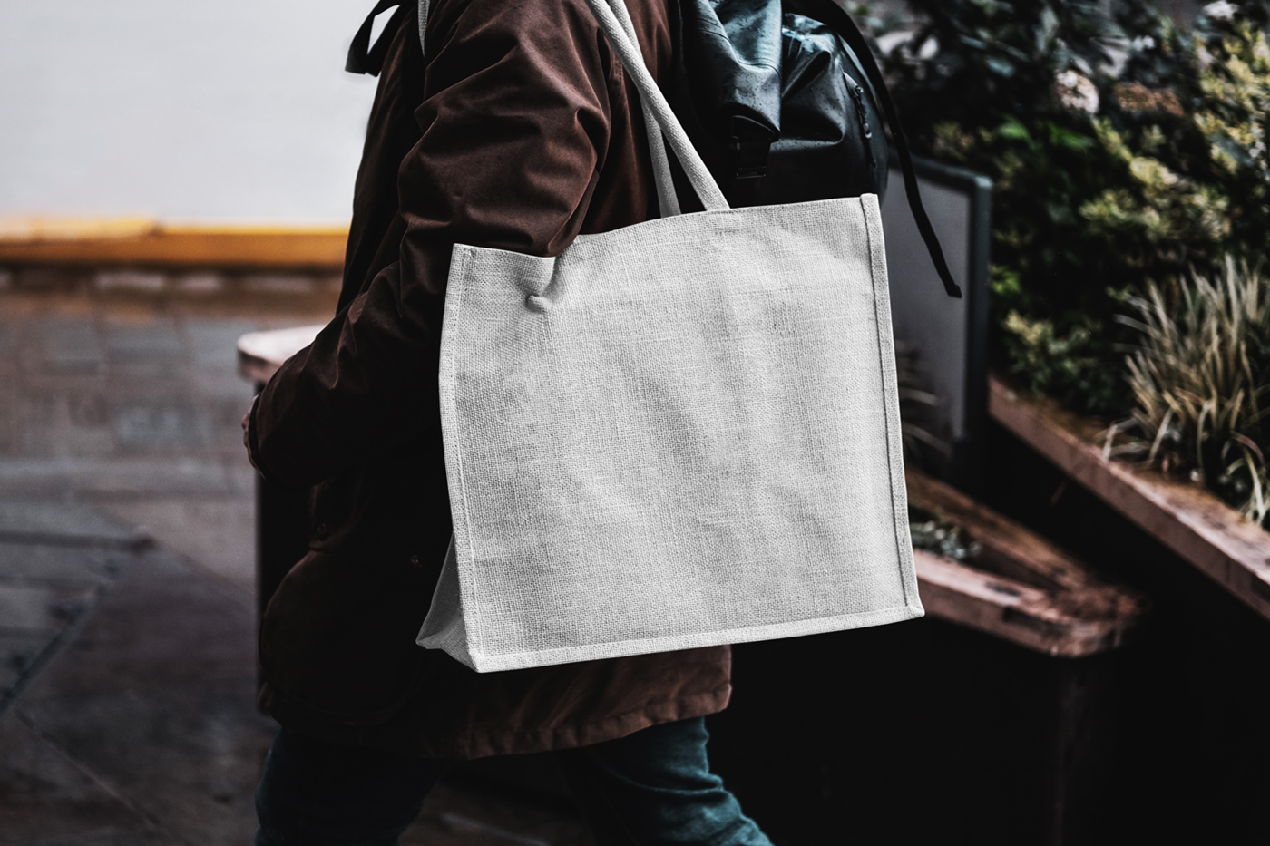 Blank eco bag mockup carried by man on his shoulder.