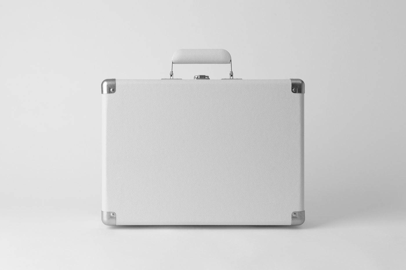 Front view, vintage white suitcase mockup laying on the white color floor.