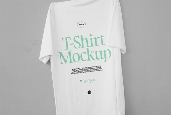 Front view, hanging t-shirt mockup on gray wall.