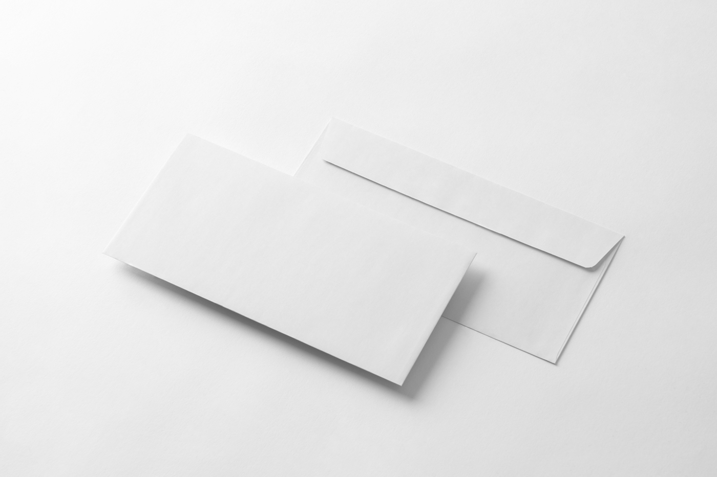 Two perspective blank envelope mockup laying on the white floor.