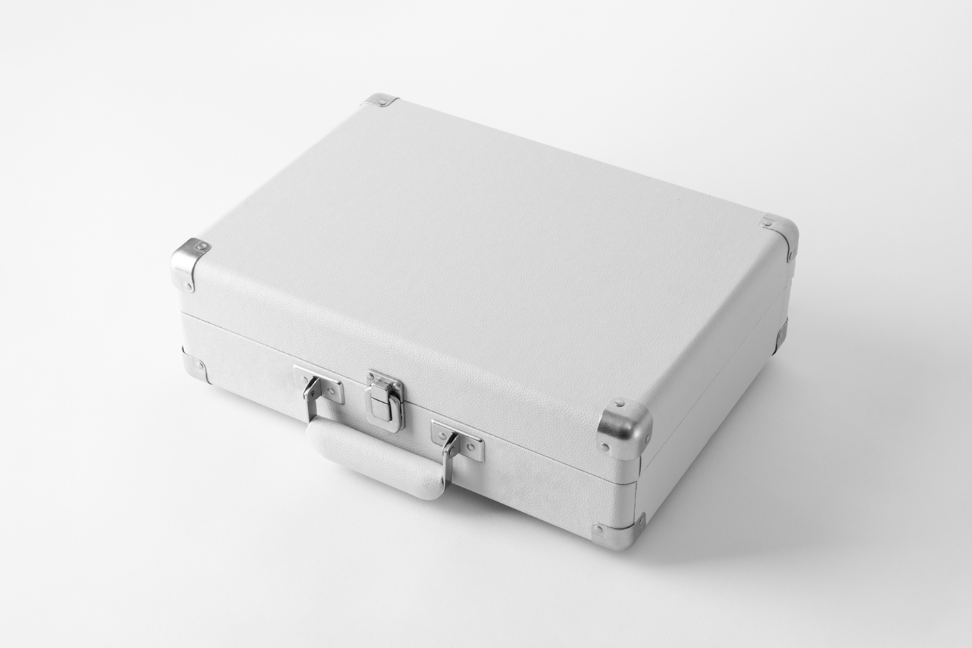 View from above, white suitcase mockup laying on the white floor.