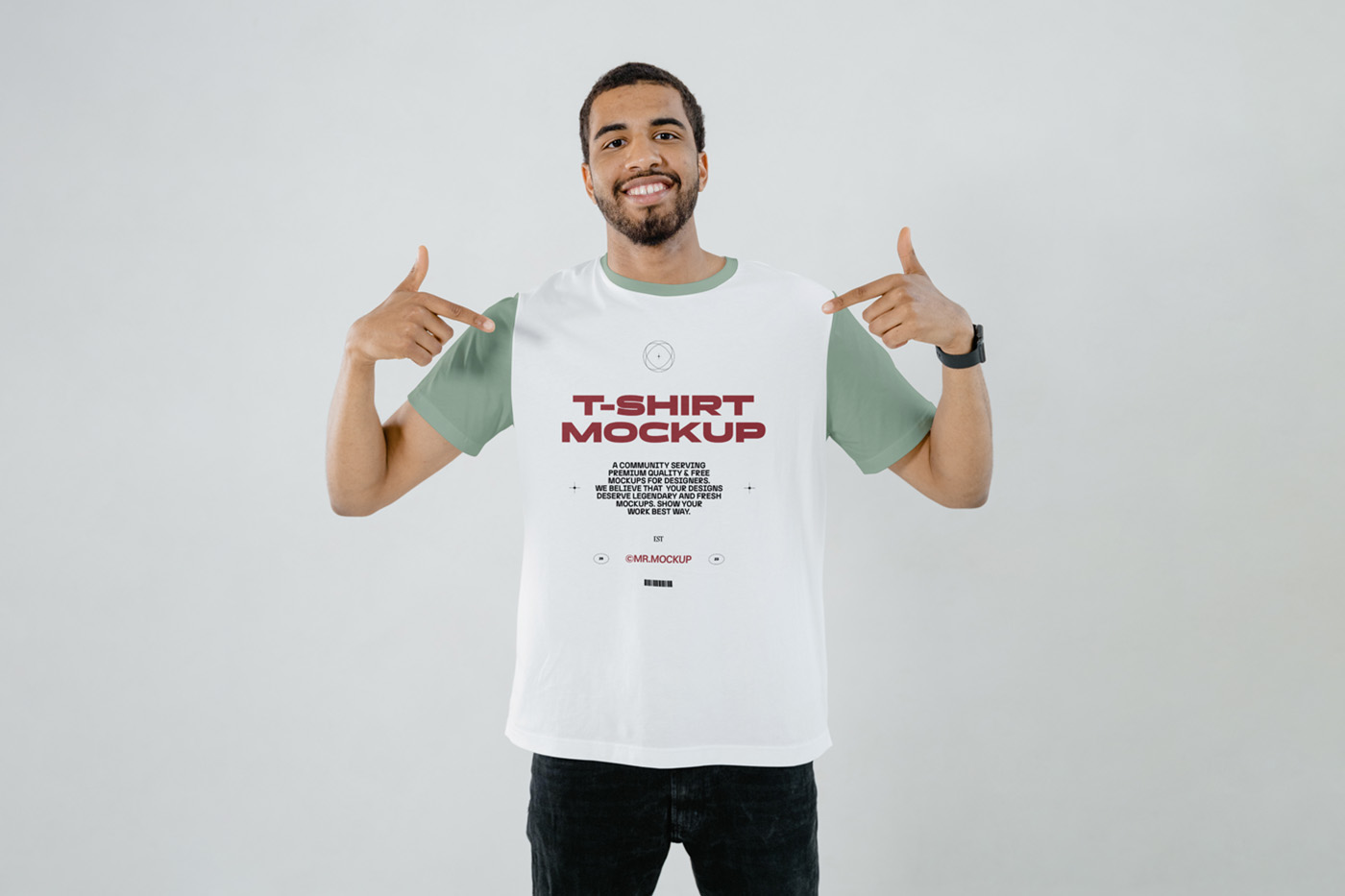 Standing men wearing t-shirt with a red typography design in front of the white wall.