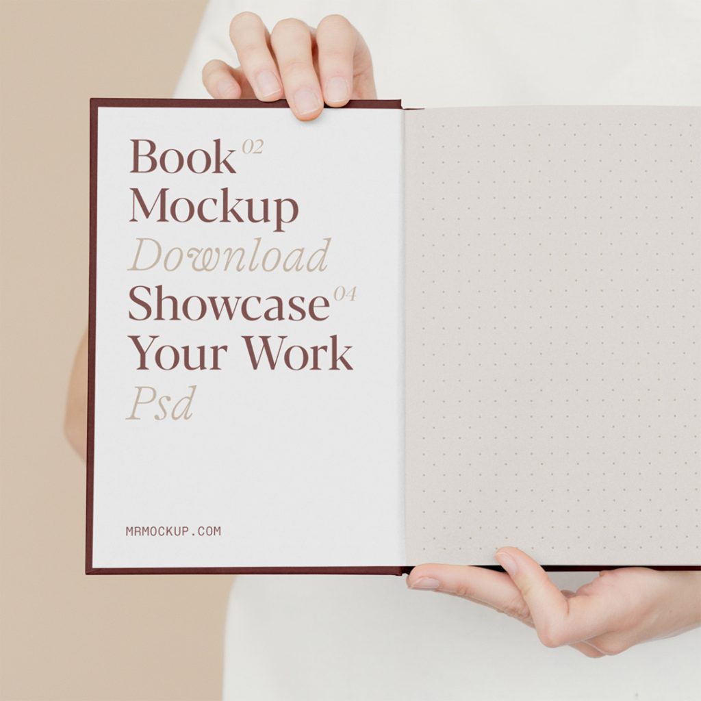 Front view, open book mockup holding by man in front of the beige wall.