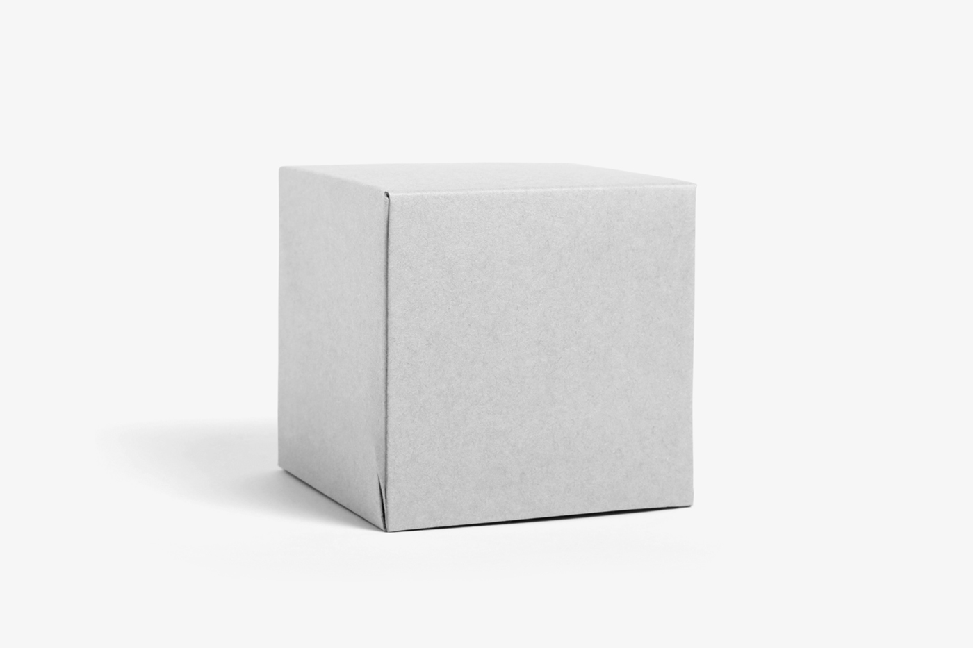 Front view, white paper square box mockup standing on the white floor.
