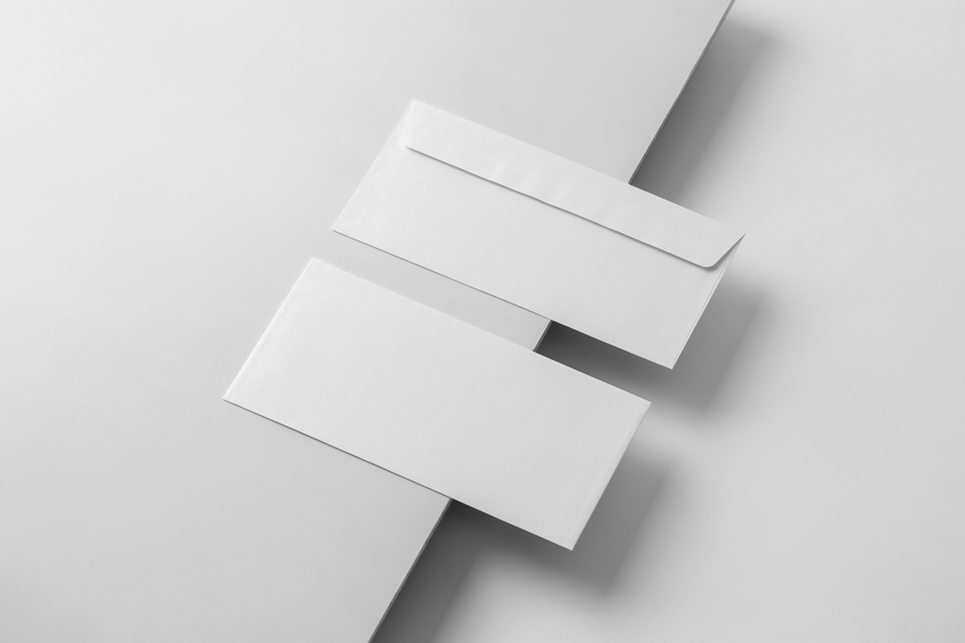 Two perspective blank envelope mockup laying on the white box.