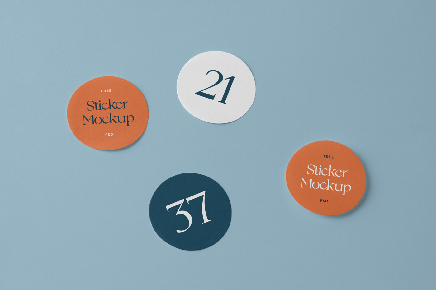 Three rounded sticker mockup laying on the blue floor.