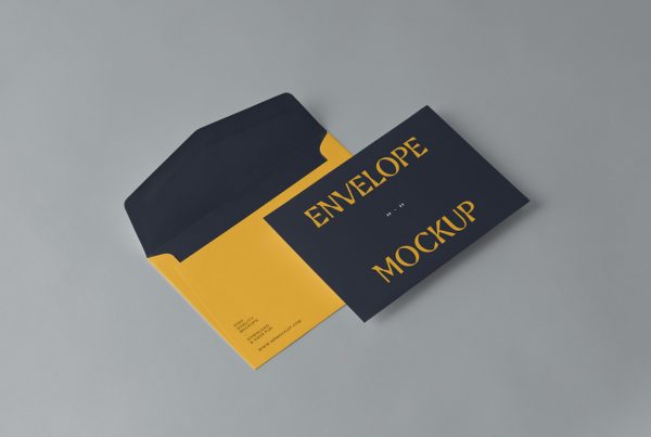 View from above, two small envelope mockup laying on the gray floor.