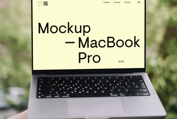 Men holding MacBook Mockup in front of the garden.