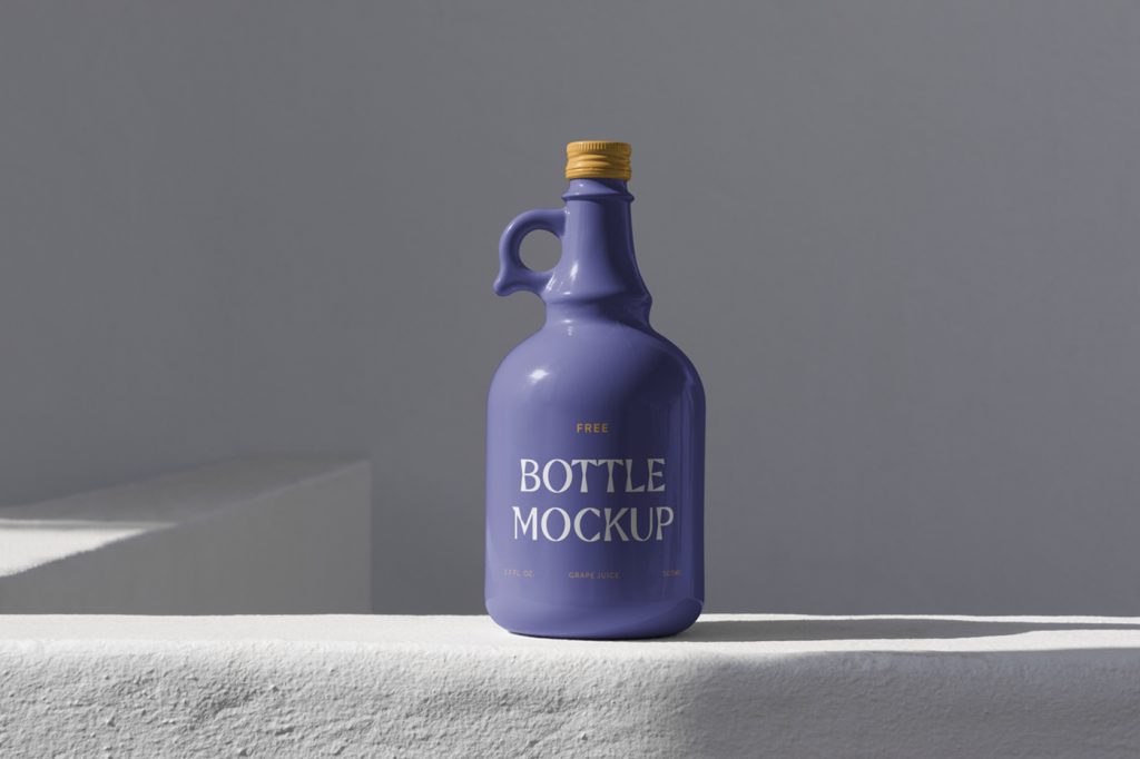 Purple ceramic bottle mockup standing on the concrete wall in front of the gray wall.