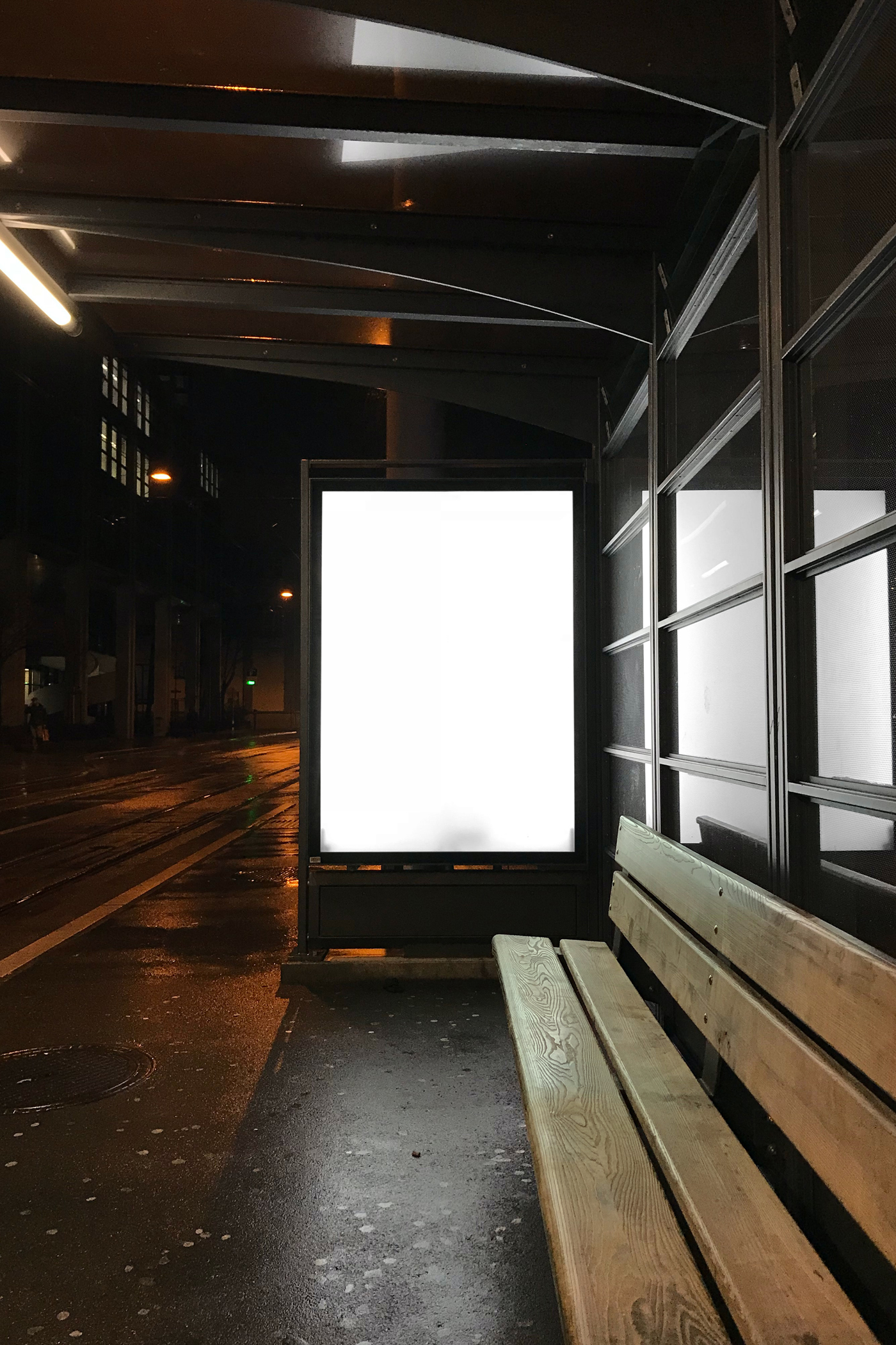 Front view, blank bus stop poster mockup at night.